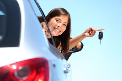 Driver holding a new car key after car key replacement in Rockville, MD